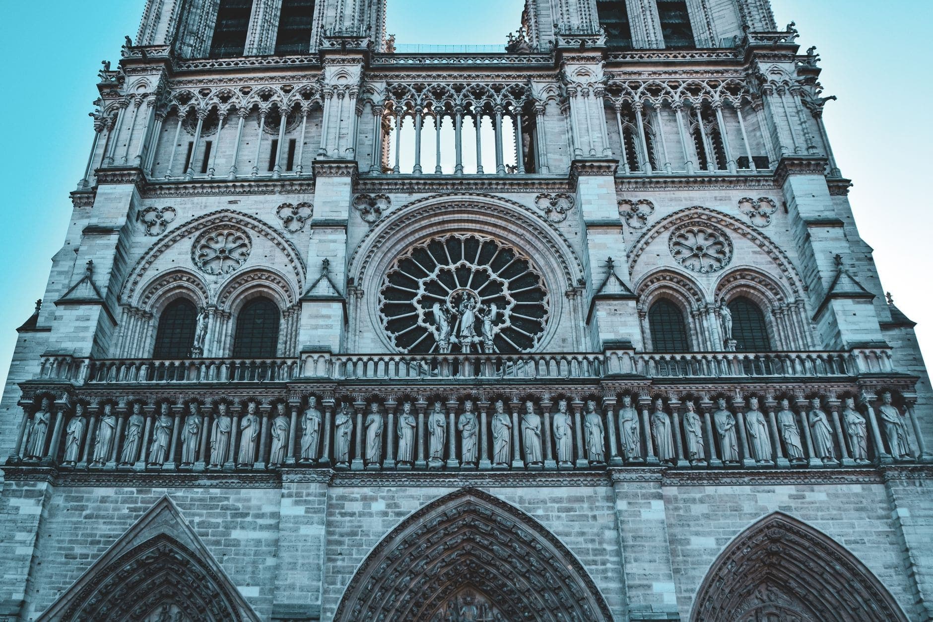 Close-up of the historic Notre Dame Cathedral facade in Paris, showcasing its stunning Gothic architecture.